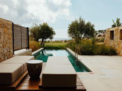 Moderner Außenbereich mit Pool, Sitzgelegenheiten und Blick auf das Meer