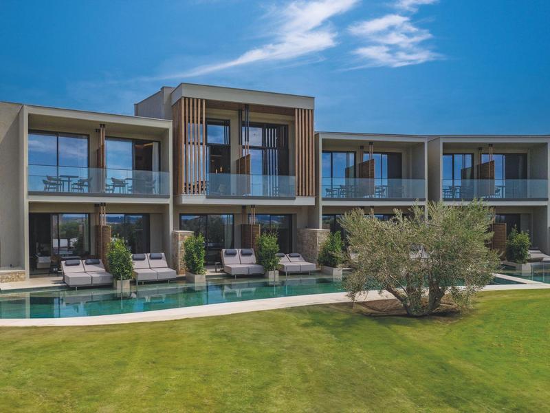 Modern hotel met zonneterras, ligstoelen en een zwembad op de voorgrond