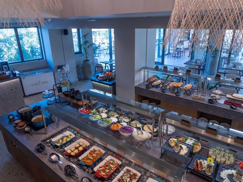 Spacious buffet with a variety of dishes in a modern hotel restaurant.