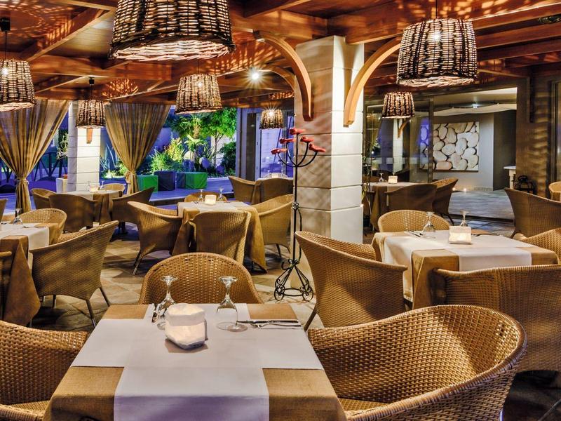 Cozy hotel restaurant with elegant tables, soft lighting, and decorative candles.