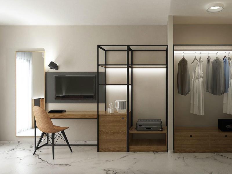 Moderner Wohnraum mit Schreibtisch, Stuhl, Wand-TV, offenem Kleiderschrank und roter Tür.