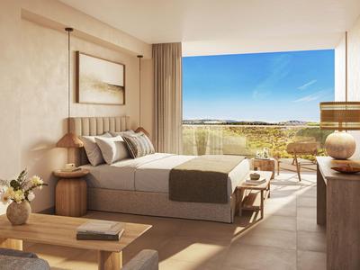 Chambre d'hôtel lumineuse avec grand lit et vue sur terrasse ensoleillée et paysage.