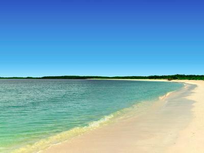 Leerer Sandstrand mit klarem blauem Wasser und bewölktem Himmel