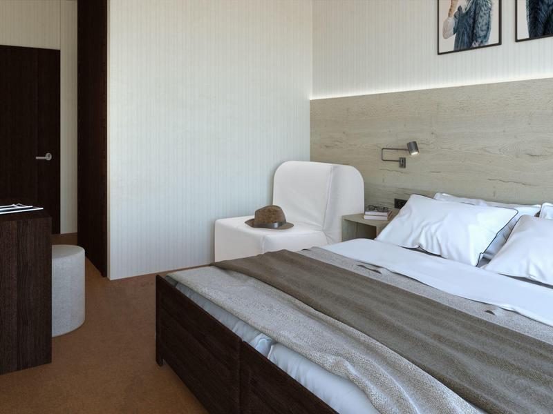 Modern hotelkamer met groot bed, bankje en minimalistische inrichting.