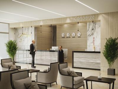 Hall d'hôtel moderne avec réception, coin salon avec fauteuils et plantes dans un cadre lumineux.