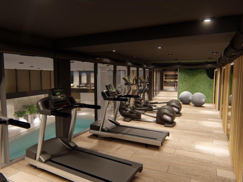 Zwei Personen sitzen auf einer Holzschaukel am Strand bei Sonnenuntergang, Palmen und Sonnenschirme im Hintergrund.