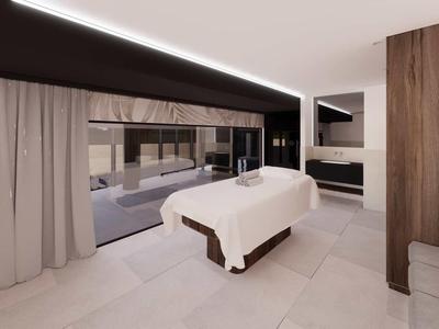 Habitación de hotel moderna con camilla de masaje, ventana grande y decoración minimalista.