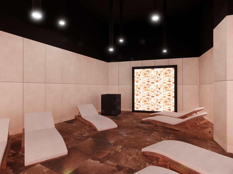 Modern wellness room with lounge chairs and an illuminated stone mosaic on the wall.