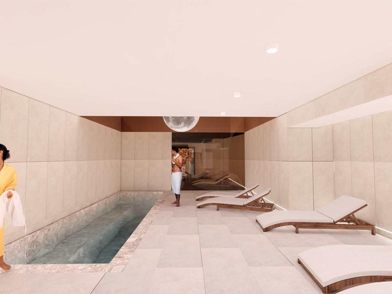 Modern wellness area with pool, lounge chairs, and relaxed atmosphere.