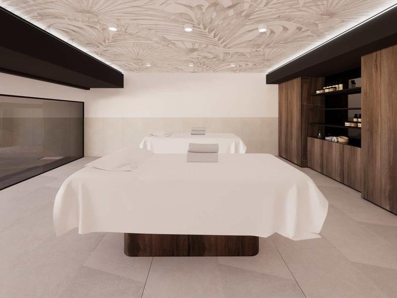 Modern spa room with massage table, elegant wooden cabinets, and calming ambiance.