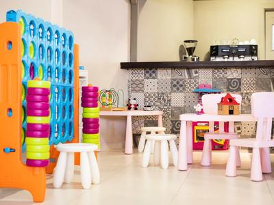Children's play area with colorful connect four and kid furniture in a modern kitchen