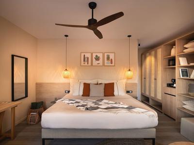 Cozy hotel room with large bed, bedside lamps, and open wardrobe.