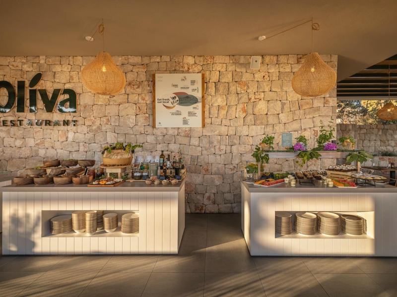 Buffet area with rustic stone wall background and decor in a hotel restaurant.