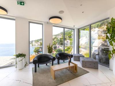 Bright, modern lounge area with large windows and sea view.