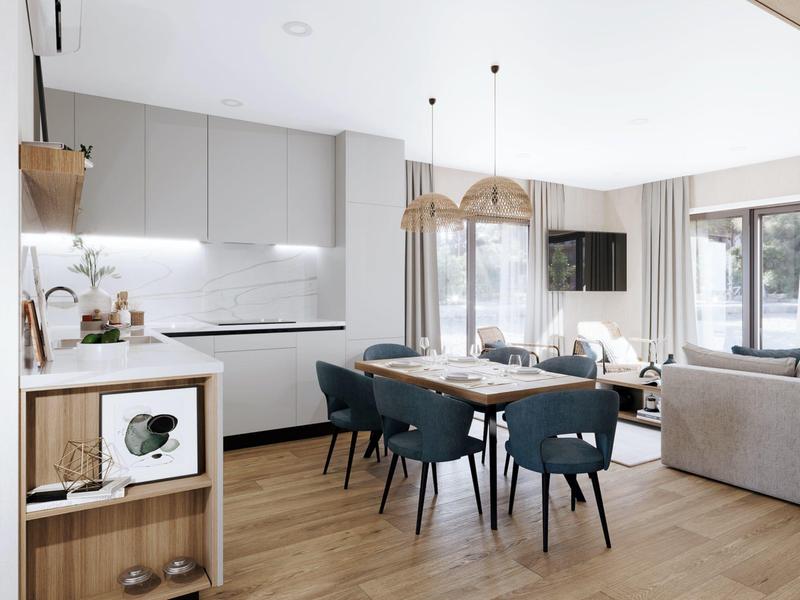 Moderní světlý obývací a jídelní prostor s kuchyňským koutem, jídelním stolem a posezením v otevřeném prostoru.