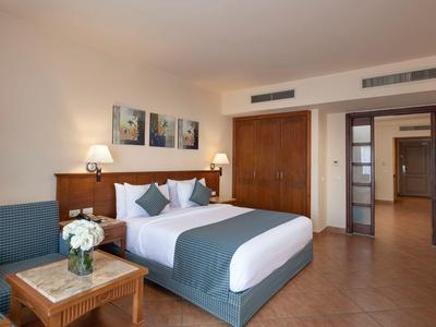 Gemütliches Hotelzimmer mit großem Bett, Holzmöbeln und entspannter Atmosphäre.