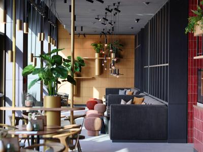 Modernes Hotelinterieur mit Sitzgelegenheiten, Pflanzen und stilvoller Beleuchtung.