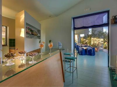 Bright room with modern reception desk and view of outdoor seating area.