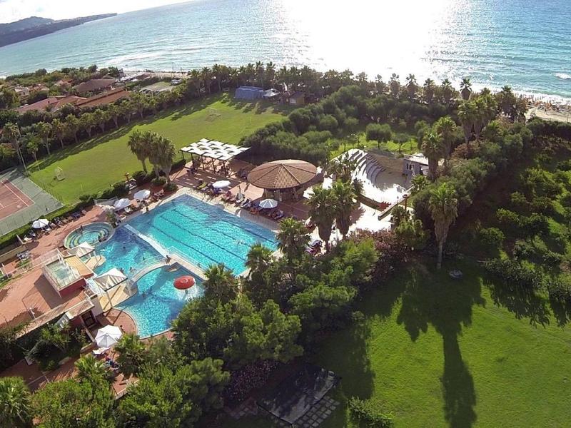 Complexe hôtelier avec grande piscine, court de tennis et accès direct à la plage.