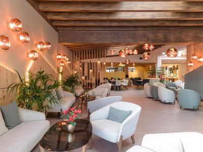 Cozy hotel lounge area with modern furnishings and warm lighting.