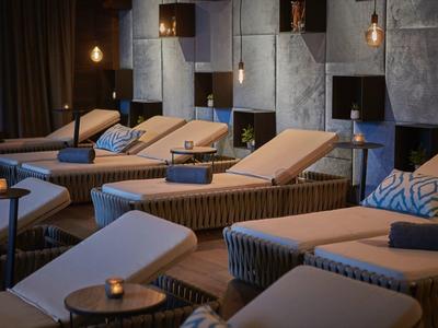 Cozy relaxation room with lounge chairs and dim lighting in a spa hotel.