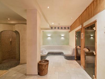 Accogliente area benessere con sauna, angoli salotto e illuminazione elegante.