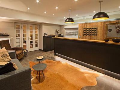 Modern hotel lobby with cozy seating area, reception desk, and warm ambiance.