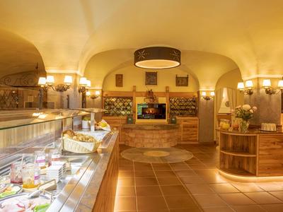 Cozy buffet area with wooden furniture and plated dishes in a hotel restaurant.