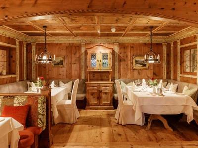 Cozy wood-paneled dining room with white tablecloths and rustic decor.