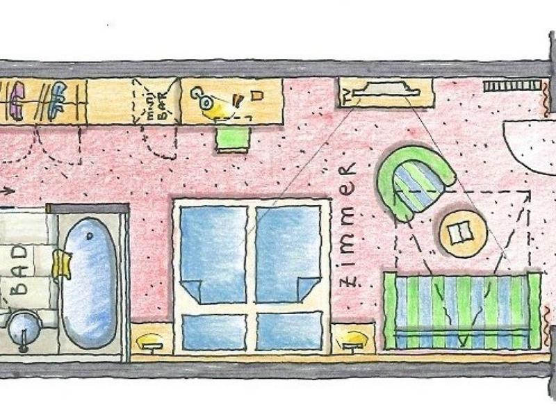 Grundriss eines Einzimmer-Apartments mit Bad, Küche, Wohnbereich und Balkon mit Tisch und Stühlen.