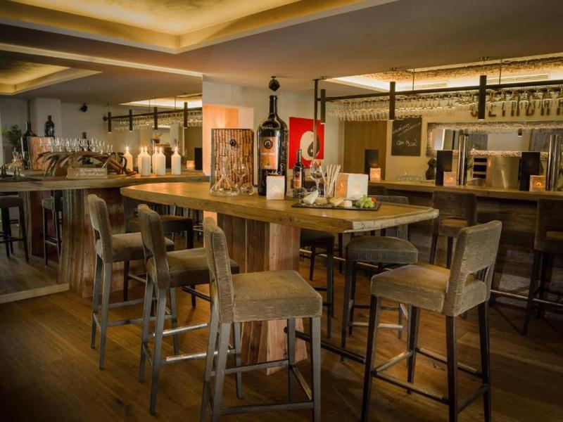 Bar accogliente con sgabelli alti in legno e luce calda