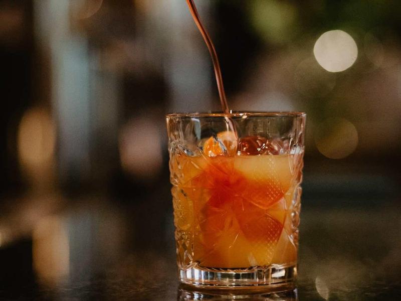 Napoje są nalewane z butelki do szklanki z kostkami lodu.