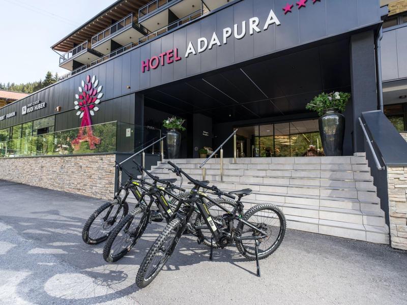 Entrance of Hotel Adapura with bicycles in front of the stairs.