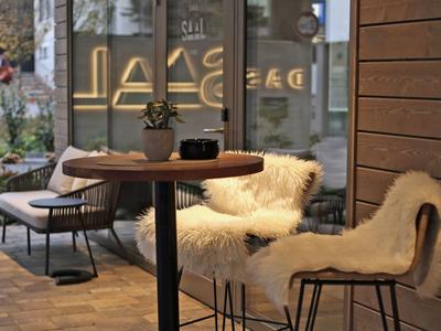 Cozy seating area with wooden table and fur-covered chairs in a restaurant or café.