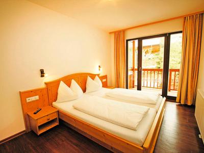 Cozy hotel room with double bed and balcony, bright and modern furnished.