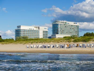 Strand met parasols voor moderne hotels onder een blauwe lucht met wolken