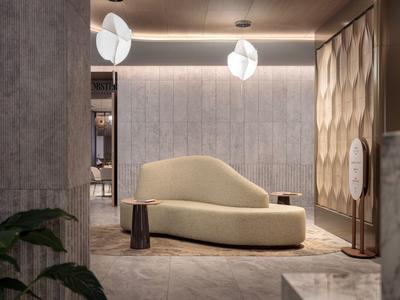 Moderner Wartebereich mit geschwungenem Sofa, stilvollen Pendelleuchten und strukturierten Wänden.