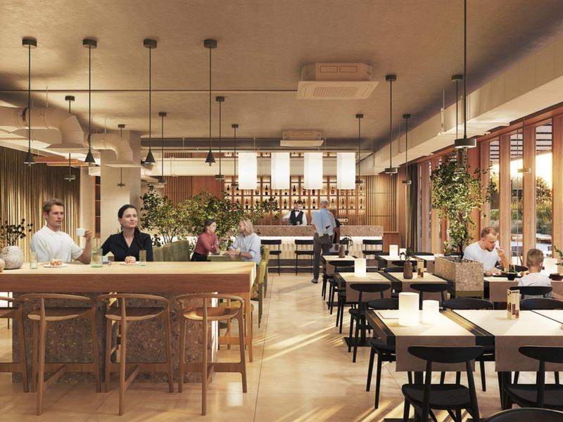 Ristorante luminoso e moderno con legno, piante, tavoli e clienti a pranzo.