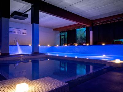 Moderner Innenpool mit blauem Licht und entspannter Atmosphäre in einem Hotel.