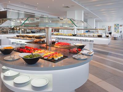 Modern buffet with a variety of dishes in a bright, spacious dining area.