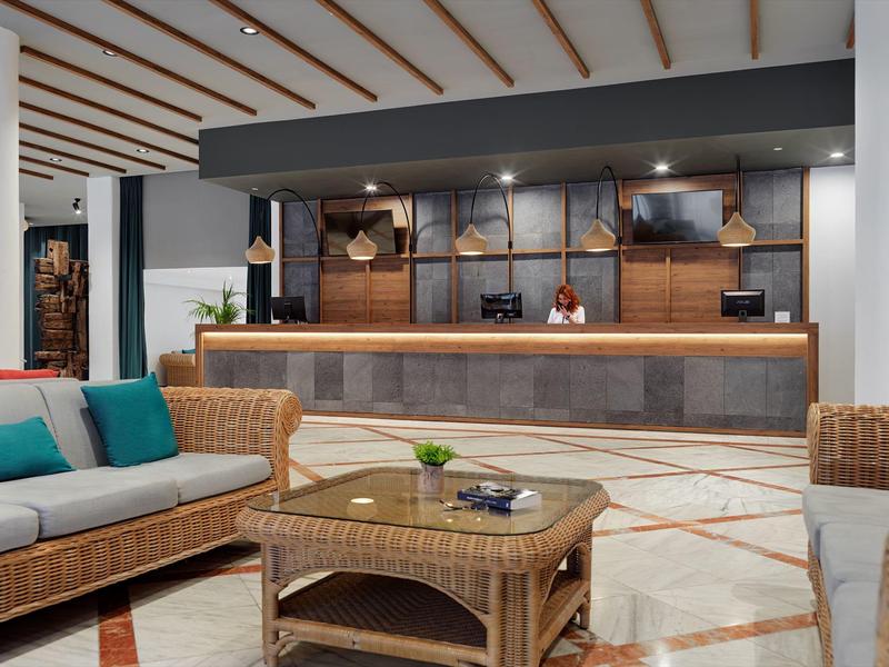 Reception moderna con arredi in vimini e atmosfera accogliente.