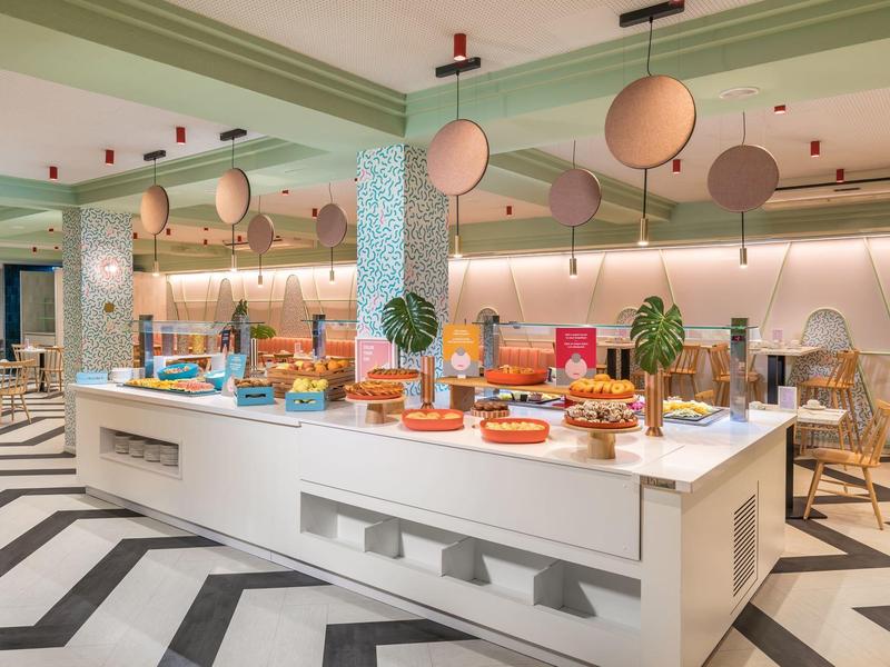 Nowoczesny bufet w jasnej sali z geometryczną podłogą.