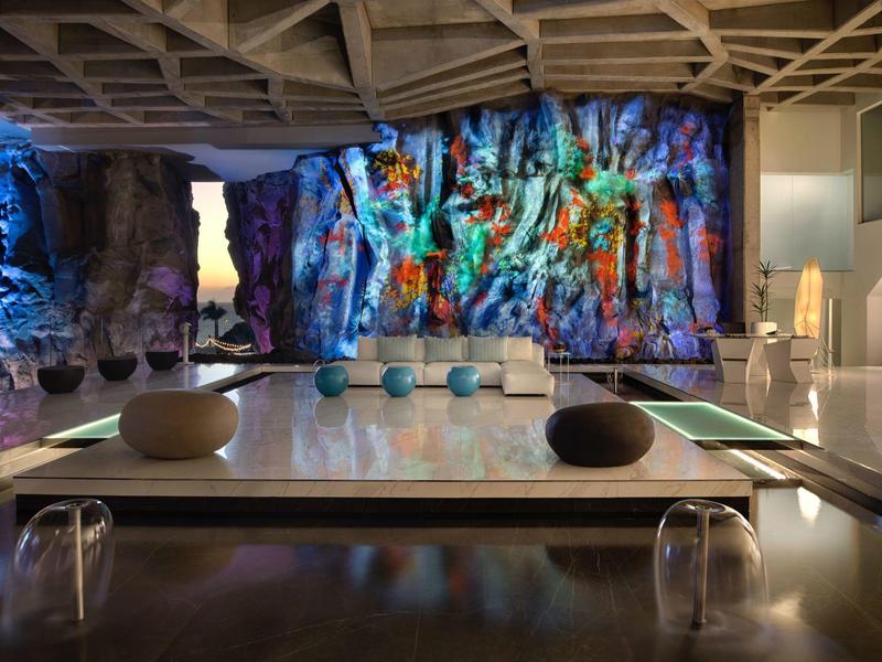 Modern lounge with colorful illuminated rock design and seating