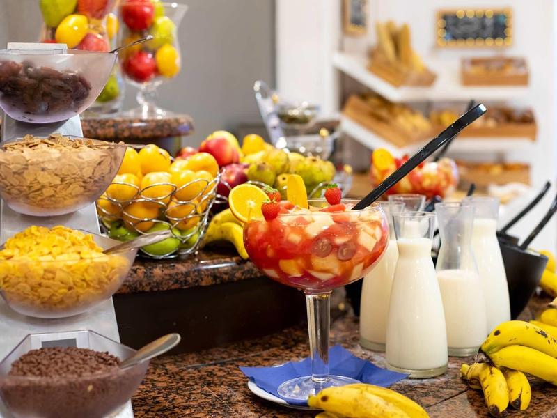 Desayuno tropical fresco con frutas, jugos y cereales, ideal para huéspedes del hotel.