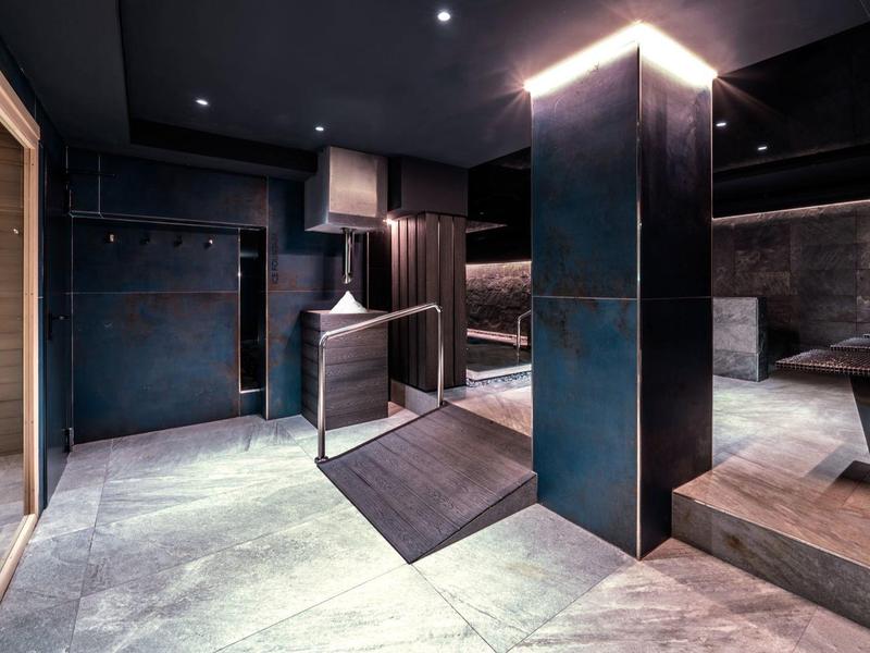 Modern dark interior with massage loungers in a spa area