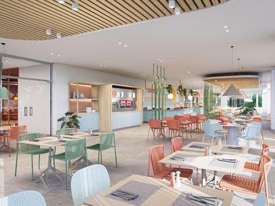 Modernes Restaurant mit bunten Stühlen und großen Fenstern, hell und einladend eingerichtet.