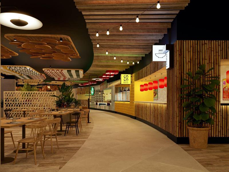 Couloir d'hôtel moderne avec espaces de sièges, accents en bois et éclairage chaud.