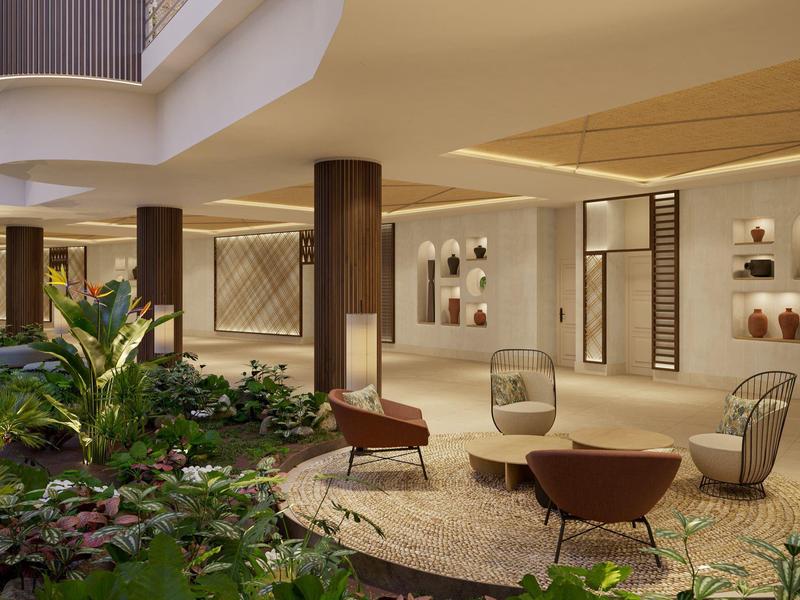 Espace intérieur moderne avec sièges et plantes vertes dans un hôtel.