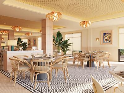 Bright restaurant with wooden chairs, round tables, and plants creating a relaxed atmosphere.