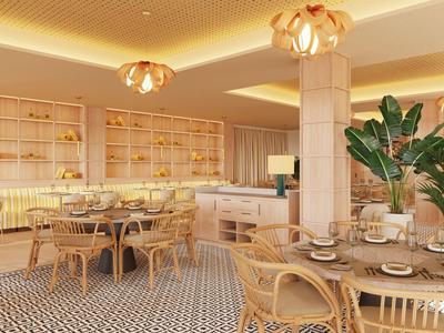 Brightly furnished hotel dining area with wooden furniture and plants